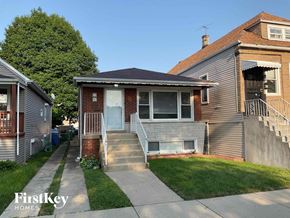 Chicago house for rent - the front of a house with stairs and a sidewalk