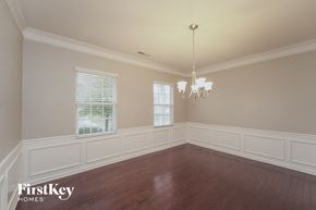Charlotte house for rent - a dining room with white wainscoting and a chandelier
