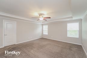 Charlotte house for rent - a bedroom with a ceiling fan and a carpet