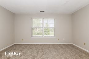 Indianapolis house for rent - a bedroom with carpet and a window