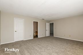 Indianapolis house for rent - a living room with a carpeted floor and white doors