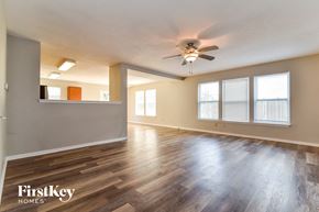 Camby house for rent - the living room and dining room with wood floors and a ceiling fan