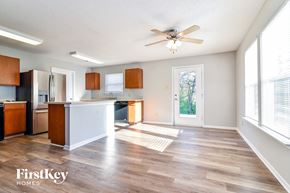 Camby house for rent - an empty kitchen and living room with a ceiling fan