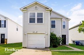 Camby house for rent - A two-story house with a garage is for sale.