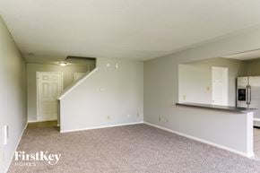 Camby house for rent - A spacious empty room with a staircase leading to the upper floor.