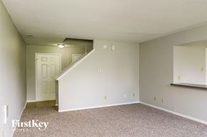 Camby house for rent - A room with a staircase leading to another room.