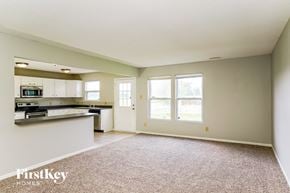 Camby house for rent - A spacious living room with a kitchen area in the background.