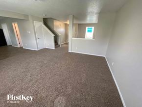 Camby house for rent - an empty living room with gray carpet and white walls