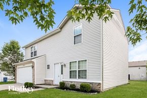 Indianapolis house for rent - a white house with white siding and a white garage door