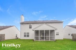Indianapolis house for rent - A house with a white exterior and a covered patio is for sale by FirstKey Homes.