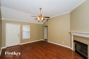 Cordova house for rent - a living room with a fireplace and a ceiling fan