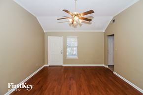 Cordova house for rent - the living room of an empty house with a ceiling fan