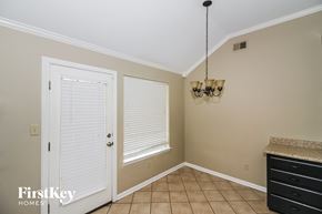 Cordova house for rent - a dining room with a door and a window and a chandelier