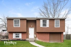 Indianapolis house for rent - A brown house with a white door and windows is for sale.
