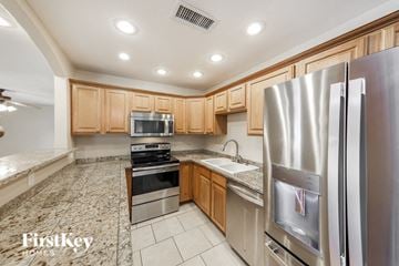 Glendale house for rent - a kitchen with stainless steel appliances and wooden cabinets
