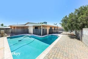 Glendale house for rent - a swimming pool and a house with a fence