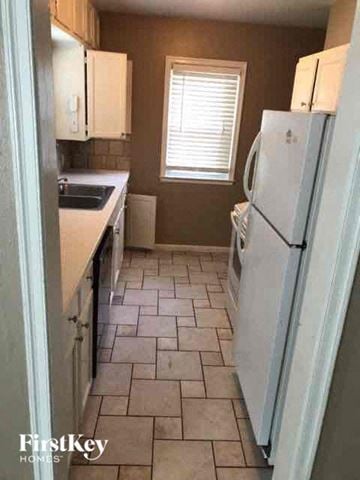 Kansas City house for rent - a small kitchen with a refrigerator and a sink