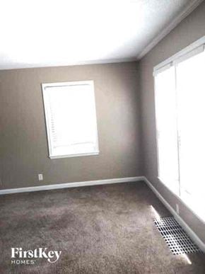 Kansas City house for rent - an empty room with a window and a carpet