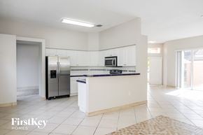 Cutler Bay house for rent - A kitchen with a refrigerator, microwave, and oven.