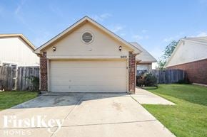 Fort Worth house for rent - a white garage door in front of a house