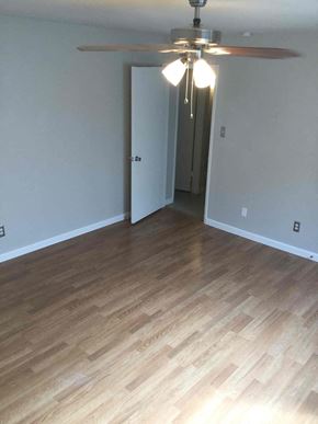 Rowlett house for rent - a living room with wood flooring and a ceiling fan