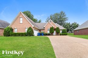 Olive Branch house for rent - a brick house with a driveway and a lawn