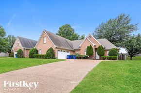 Olive Branch house for rent - a large brick house with a driveway and lawn