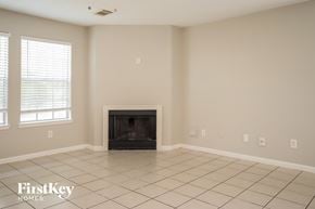 Houston house for rent - a living room with a fireplace and a tiled floor