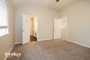 Houston house for rent - a bedroom with a carpeted floor and white doors