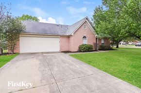 Southaven house for rent - a brick house with a driveway and a white garage door