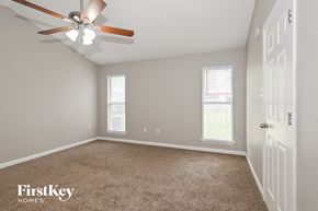 Southaven house for rent - a bedroom with a ceiling fan and a white door