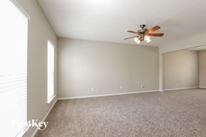Charlotte house for rent - A room with a ceiling fan and carpeted floor.