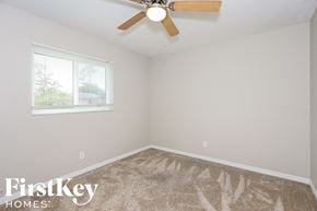 Fort Myers house for rent - a bedroom with a ceiling fan and a window