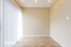 Orland Hills house for rent - A room with beige walls and floor, a window with white blinds, and recessed lighting.