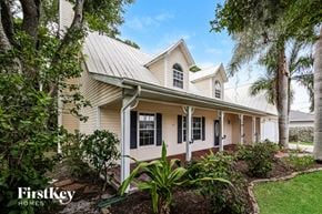 Fort Myers house for rent - a white house with a yard and trees