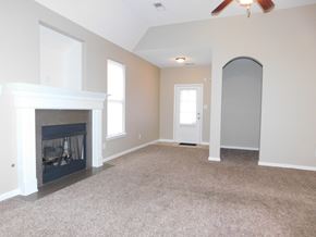 Cordova house for rent - A room with a fireplace and a ceiling fan.