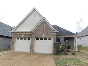 Cordova house for rent - A house with two garages and a brick facade.