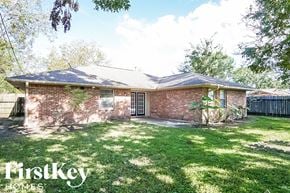 Texas City house for rent - the front of a brick house with a yard and grass