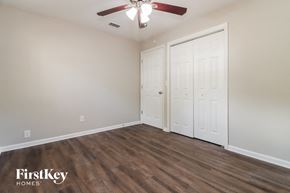 Tampa house for rent - an empty bedroom with a ceiling fan and two closets