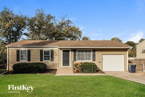 Kansas City house for rent - a home with a lawn and a white garage door