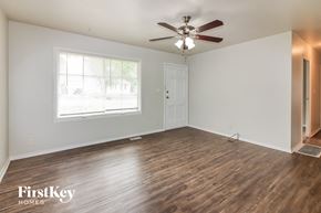 Kansas City house for rent - the living room of an empty house with a ceiling fan