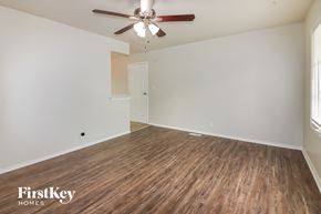Kansas City house for rent - the living room of an empty house with wood flooring and a ceiling fan