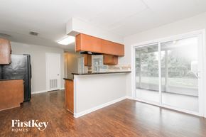 Tampa house for rent - A kitchen with a refrigerator, cabinets, and a countertop is shown in a real estate listing.