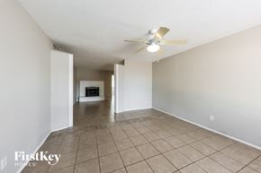 Glendale house for rent - A spacious room with a fan and tiled floor.