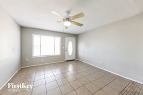 Glendale house for rent - A room with a fan, tile floor, and a window.