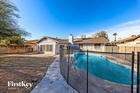 Glendale house for rent - A pool in a backyard with a house and a fence.