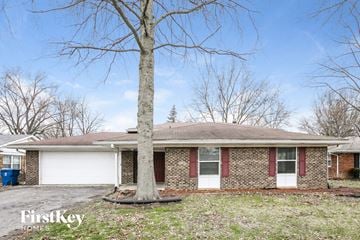 Indianapolis house for rent - a brick house with a tree in front of it