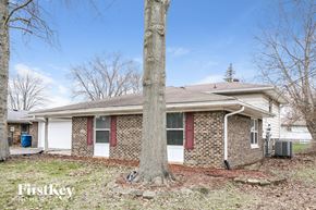 Indianapolis house for rent - a brick house with a tree in front of it