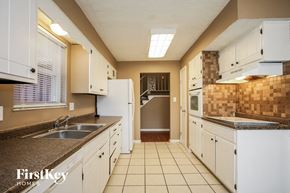 Indianapolis house for rent - full view of kitchen with white cabinets and counters and white appliances
