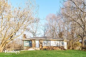 Kansas City house for rent - a small bungalow on a lawn with trees